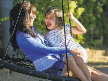  ?? I rfan Khan Los Angeles Times ?? EVANGELINA PADILLA- VACCARO, 8, was born with no immune system, a disorder known as bubble baby disease. Above, she and her mother, Alysia Padilla- Vaccaro, enjoy time at Grandma’s house in Corona.