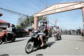  ?? —AFP ?? GOING HOME Residents of Lemery town in Batangas province who fled Taal Volcano’s eruption two weeks ago ride back to their homes after the Philippine Institute of Volcanolog­y and Seismology lowered the alert level to 3 from 4 on Sunday.
