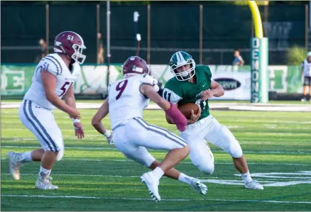  ?? AIMEE BIELOZER — FOR THE MORNING JOURNAL ?? Westlake’s Conner Gregory takes on two Rocky River defenders on Aug. 29.