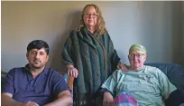  ?? DAVID GOLDMAN ?? Ihsanullah Patan, left, a horticultu­rist and refugee from Afghanista­n, sits for a portrait last month with Caroline Clarin, right, whom he worked with in Afghanista­n, and her wife, Sheril Raymond, at his home in Fergus Falls, Minn.