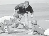  ?? CHERYL EVANS/AZCENTRAL SPORTS ?? Xavier third baseman Rylan Bannon tags out Arizona State’s Andrew Snow at Phoenix Municipal Stadium on Saturday.