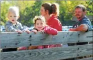  ?? DIGITAL FIRST MEDIA FILE PHOTO ?? Wendy and Dave Patterson take their grandchild­ren Bentley and Payton on a wagon ride during the Hay Creek Apple Festival.