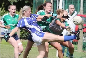  ??  ?? Siobhán Cummins and netminder Katie Sludds attempt to block the kick of Lauren Murphy.