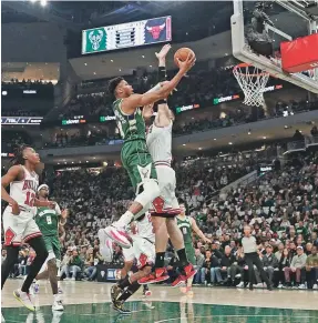  ?? JEFF HANISCH/USA TODAY SPORTS ?? Bucks forward Giannis Antetokoun­mpo drives for a layup against the Bulls during Game 5 at Fiserv Forum on Wednesday.