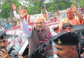  ?? SUBHANKAR CHAKRABORT­Y/ HT PHOTO ?? BJP president Amit Shah being greeted by party workers in Lucknow on Saturday. Also seen are chief minister Yogi Adityanath and deputy CM Keshav Prasad Maurya.