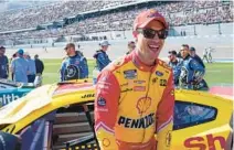  ?? JOHN RAOUX/AP ?? Joey Logano laughs with friends and family members on pit road before the start of the 2022 Daytona 500 in which he finished 21st.