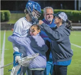  ?? KARL MERTON FERRON/STAFF ?? The Earl family shares a moment after a recent game.