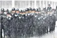  ??  ?? Rain on my parade: new officer graduates
