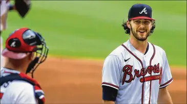  ?? CURTIS COMPTON / CCOMPTON@AJC.COM ?? Braves top pitching prospect Ian Anderson smiles at catcher Tyler Flowers during his major-league debut last week in Atlanta.