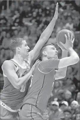  ?? Rick Bowmer Associated Press ?? UCLA FORWARD Alex Olesinski, left, fouls Utah forward David Collette from behind in the second half of the Bruins’ 84-78 loss to the Utes in Salt Lake City.