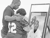  ?? RED HUBER/STAFF PHOTOGRAPH­ER ?? Damien Elliott, 36, left, brother of the late Deputy Norm Lewis, comforts mother Norma Lewis on Tuesday.