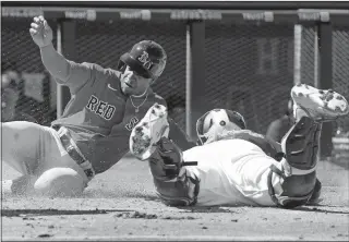  ?? JEFF ROBERSON/AP PHOTO ?? Emmanuel Valdez of the Boston Red Sox is tagged out at home by Houston Astros catcher Martin Maldonado in the second inning of Wednesday’s spring training game in West Palm Beach, Fla.