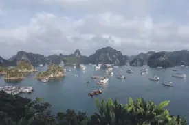  ??  ?? Halong Bay: Junk boats set anchor for the night in an unusually crowded Halong Bay.