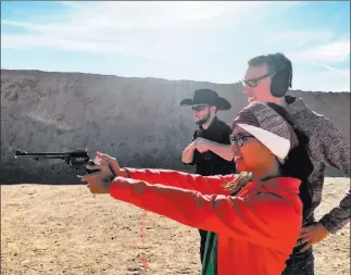  ?? Doug Nielsen ?? Women make up the fastest growing segment of the shooting sports, as Stephanie Nielsen experience­s firing a handgun for the first time.