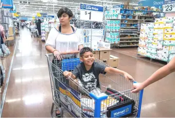  ??  ?? Ethan and Emily shop for school supplies with their mom. — Photos by Mary F. Calvert For The Washington Post