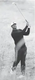  ?? PETER MORRISON / THE ASSOCIATED PRESS ?? Tiger Woods of the U.S. plays out of the rough on the second hole during a practice round on Tuesday in Scotland.