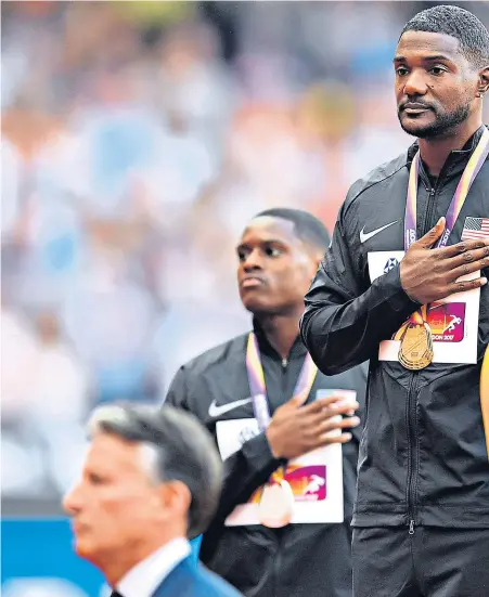  ??  ?? Villain of the piece: Justin Gatlin, centre, takes gold ahead of his rivals