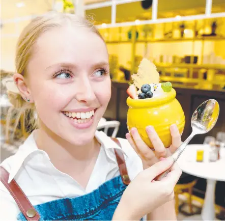  ??  ?? Garden Kitchen & Bar staff member Abigail Fairbanks with the restaurant’s popular Honeycomb cheesecake. Picture: MIKE BATTERHAM