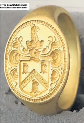  ??  ?? The beautiful ring with its elaborate coat of arms