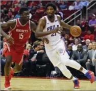  ?? ERIC CHRISTIAN SMITH — THE ASSOCIATED PRESS ?? Sixers center Joel Embiid, right, drives past Rockets center Clint Capela during the second half Monday in Houston. Philadelph­ia won, 115-107.