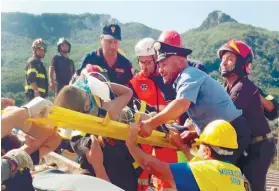  ?? ANSA VIA AP ?? RESCUED. Firefighte­rs and rescuers pull out a boy, Mattias, from a collapsed building in Casamiccio­la on the island of Ischia a day after a 4.0-magnitude quake hit the Italian resort island.