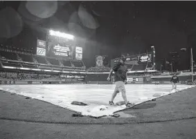  ?? David Berding / Getty Images ?? The hopes of getting in at least five innings Wednesday were dashed as the field was covered before the fourth could get underway.