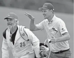  ?? CURTIS COMPTON/ATLANTA JOURNAL-CONSTITUTI­ON VIA AP ?? Justin Rose, right, and caddie David Clark react to his second shot on the 18th hole Thursday at the Masters in Augusta, Ga.