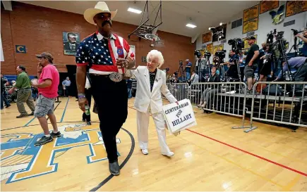  ?? PHOTO: REUTERS ?? Jerry Emmett, 102, right, at a campaign rally for Hillary Clinton in Phoenix, Arizona. Emmett cast the Arizona delegation’s 34 votes for Clinton at the Democratic National Convention.