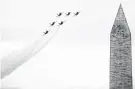  ?? Andrew Harnik / Associated Press ?? The Navy Blue Angels fly past the Washington Monument during the Independen­ce Day celebratio­n.