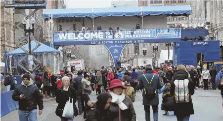  ?? STAFF PHOTO BY NICOLAUS CZARNECKI ?? ON YOUR MARKS: Crowds visit the finish line on Boylston Street in Boston yesterday, the day before today’s 122nd Boston Marathon, the world’s oldest annual marathon.