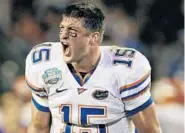  ?? MARK HUMPHREY/ASSOCIATED PRESS ?? Tim Tebow yells to his teammates during the 2008 national championsh­ip game against Oklahoma, which UF won 24-14.