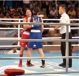  ??  ?? M.C. Mary Kom embraces North Korea’s Kim Hyang Mi after the Asian Championsh­ips 48kg final in Ho Chi Minh City on Wednesday. Mary won by a 5-0 verdict.