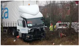  ??  ?? Wreck: The lorry was shunted into a river beside the road