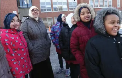  ?? MATHEW MCCARTHY, RECORD STAFF ?? Rania Lawendy, principal at the Muslim Associatio­n of Canada Maple Grove School, laughs with her students during a recess on Thursday.