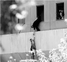  ?? — Reuters photo ?? Emad is evacuated during an attack on the Iranian parliament in central Tehran, Iran.