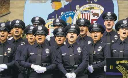  ?? Irfan Khan Los Angeles Times ?? LAPD RECRUITS sing during their graduation ceremony June 3. The agency is expecting 600 of its 9,200 officers to leave in the next year.