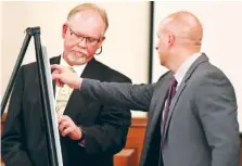  ?? THE ASSOCIATED PRESS ?? Tennessee Bureau of Investigat­ion Special Agent Brent Booth, left, shows Assistant District Attorney Paul Hagerman where items belonging to Holly Bobo were found by former witnesses who testified. Day five of the Holly Bobo murder trial was held Friday...