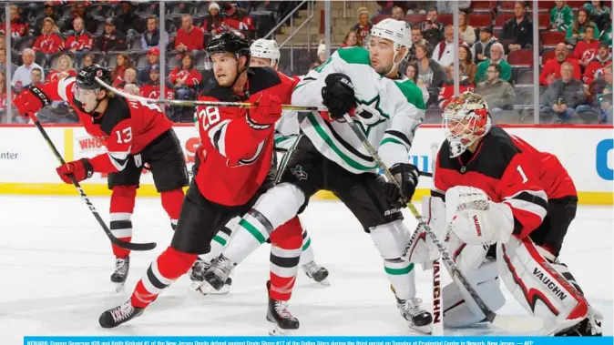  ?? — AFP ?? NEWARK: Damon Severson #28 and Keith Kinkaid #1 of the New Jersey Devils defend against Devin Shore #17 of the Dallas Stars during the third period on Tuesday at Prudential Center in Newark, New Jersey.