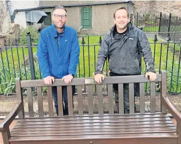  ?? ?? Happy to help Friends of Crieff Cemetery chair Mark Hunter with fellow volunteer Craig Finlay, who also volunteers with Friends of Old St Michael’s. They are pictured with a bench Craig has restored which was donated by Crieff in Leaf and is soon to be installed at the cemetery