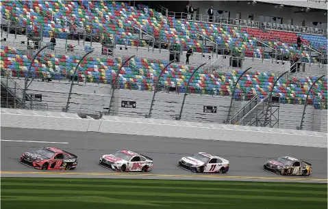  ?? AP Photo/John Raoux ?? ■ NASCAR drivers, from left, Martin Truex Jr. (19), Erik Jones (20), Denny Hamlin (11) and Kyle Busch (18) runs practice laps during auto race practice Saturday at Daytona Internatio­nal Speedway in Daytona Beach, Fla.