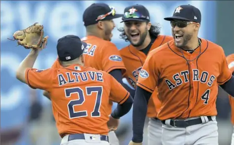  ?? David Dermer/The Associated Press ?? Jose Altuve, left, and the Houston Astros beat the Cleveland Indians, 11-3, to sweep their ALDS Monday in Cleveland.