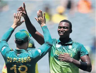  ?? /Ryan Pierse/Getty Images ?? High fives: Lungi Ngidi celebrates taking the wicket of Aaron Finch with SA captain Faf du Plessis.