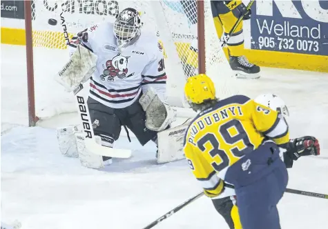  ?? JULIE JOCSAK/ STANDARD FILE PHOTO ?? Niagara goaltender Stephen Dhillon, shown making a save against Erie's Gera Poddubnyi in November, backstoppe­d the Ontario Hockey League team to come- from- behind overtime victory Thursday night in North Bay.