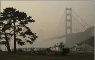  ?? ERIC RISBERG ?? FILE - In this Nov. 16, 2018, file photo, the Golden Gate Bridge is obscured by smoke and haze from wildfires in this view from Fort Baker near Sausalito, Calif. Tens of millions of people in the Western US face a growing health risk due to wildfires as more intense and frequent blazes churn out greater volumes of lung-damaging smoke, according to research scientists at NASA and several major universiti­es.