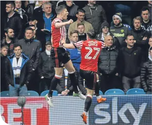  ??  ?? Paddy Mcnair jumps for joy with Liam Gooch after opening the scoring