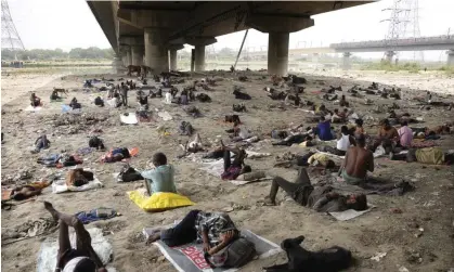  ?? Photograph: Manish Swarup/AP ?? Homeless people sleep in the shade of a bridge in Delhi, India, one of the countries disproport­ionately affected by the cost of extreme heat.