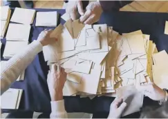  ??  ?? 0 Ballots are prepared for counting at a polling station in Rouen