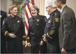  ??  ?? Kirkpatric­k, who led department­s in Washington state, celebrates at her swearing-in ceremony at City Hall with members of the force.