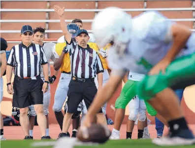  ?? JIM THOMPSON/JOURNAL ?? Officials Ken Rosales, left, and Gilbert Sisneros work a scrimmage Wednesday at Milne Stadium. The number of football officials in the state has been described as “miserably low.”