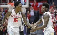  ?? DAVID JABLONSKI / STAFF ?? Dayton’s John Crosby (15) and Jordan Davis react after a 3-pointer by Davis in overtime against Georgia State on Saturday at UD Arena.